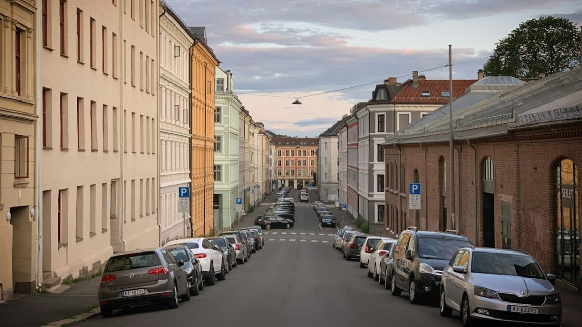 A street with the old houses and the parked cars in the Grünerløkka district of Oslo, Norway, August 2019