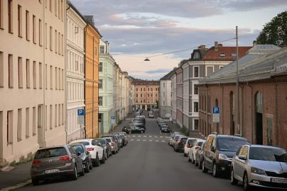 A street with the old houses and the parked cars in the Grünerløkka district of Oslo, Norway, August 2019